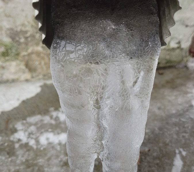 a close up of a statue with ice on it